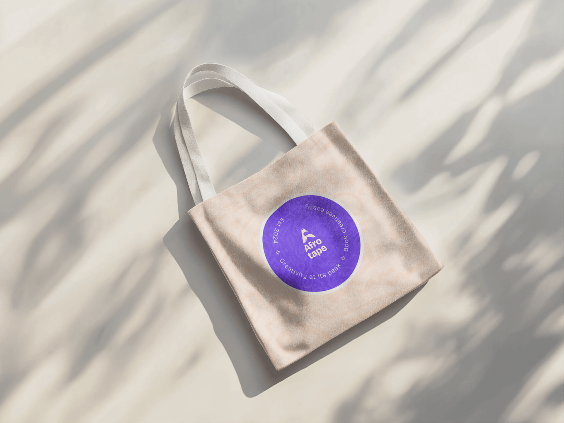 Afro Tape cream canvas tote bag with circular purple brand badge